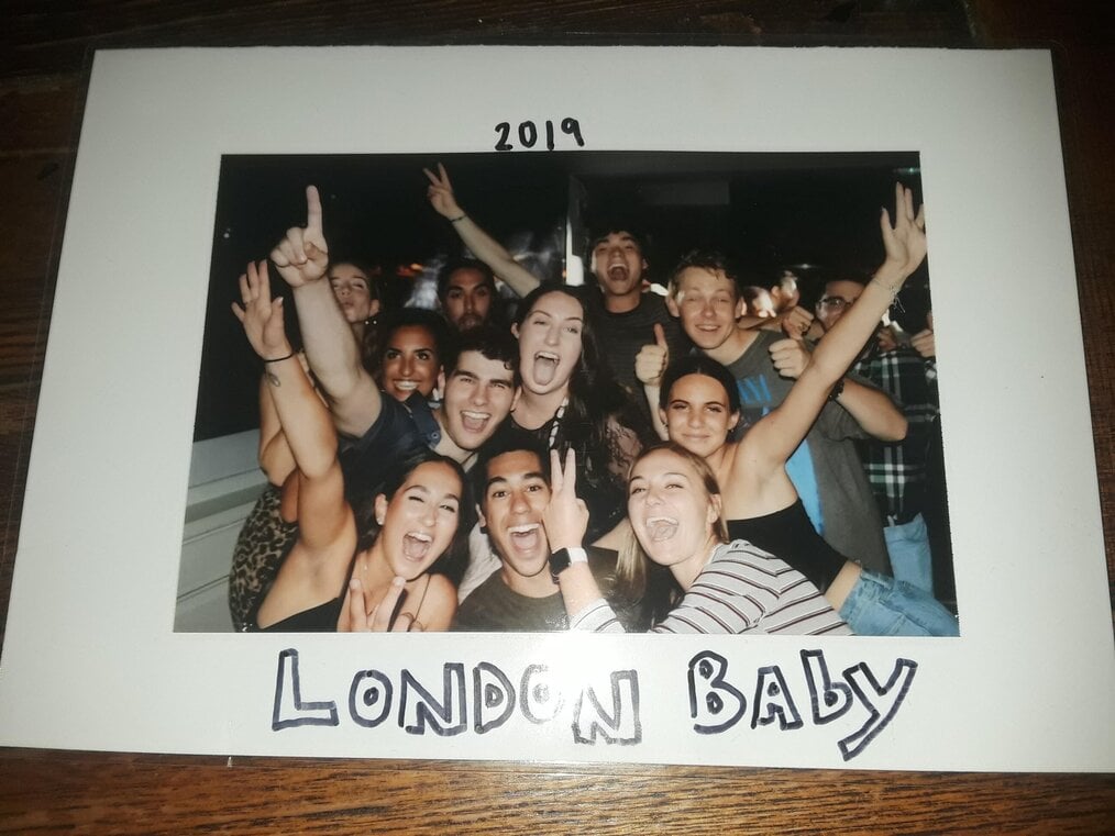 Photo by Aj R., Global Experiences London Alum A polaroid of a large group of friends with 2019 London Baby written on it