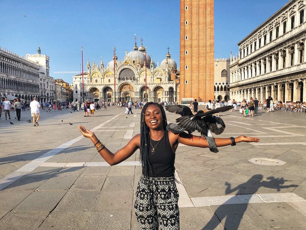 Photo by Rita N., CAPA Florence Alum A girl standing with birds landed on her arm